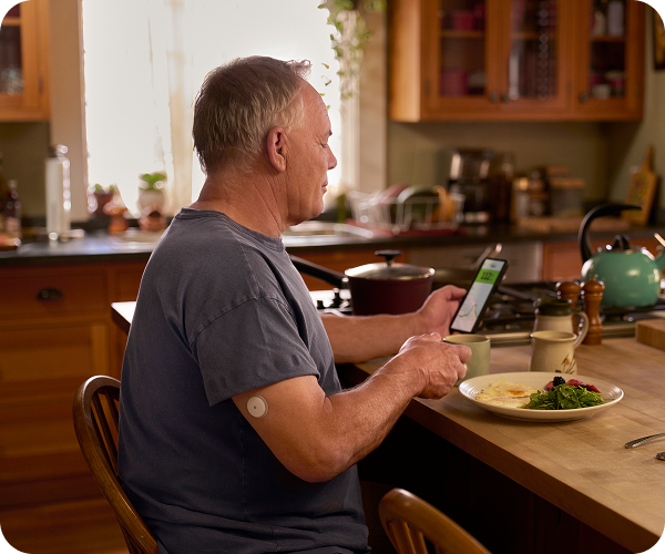 man with coffee FreeStyle Libre Glucose monitors